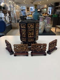 A Chinese octagonal gilt-lacquered wooden stand and four wooden carvings on stands, 19th C.