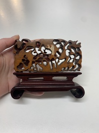 A Chinese octagonal gilt-lacquered wooden stand and four wooden carvings on stands, 19th C.