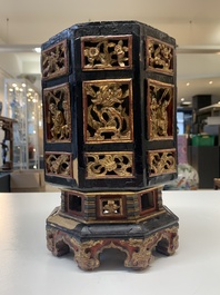 A Chinese octagonal gilt-lacquered wooden stand and four wooden carvings on stands, 19th C.