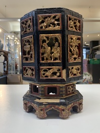 A Chinese octagonal gilt-lacquered wooden stand and four wooden carvings on stands, 19th C.