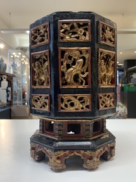 A Chinese octagonal gilt-lacquered wooden stand and four wooden carvings on stands, 19th C.