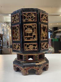 A Chinese octagonal gilt-lacquered wooden stand and four wooden carvings on stands, 19th C.