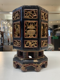A Chinese octagonal gilt-lacquered wooden stand and four wooden carvings on stands, 19th C.