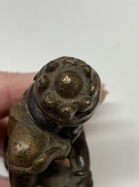 A small Chinese gilt bronze paperweight in the form of a kneeling foreigner, Ming