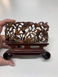 A Chinese octagonal gilt-lacquered wooden stand and four wooden carvings on stands, 19th C.