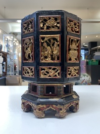 A Chinese octagonal gilt-lacquered wooden stand and four wooden carvings on stands, 19th C.