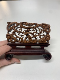 A Chinese octagonal gilt-lacquered wooden stand and four wooden carvings on stands, 19th C.