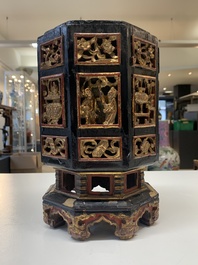 A Chinese octagonal gilt-lacquered wooden stand and four wooden carvings on stands, 19th C.