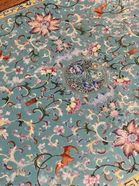 A Chinese famille rose turquoise-ground 'flower scrolls and bats' plaque, later mounted as table, Qianlong