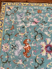 A Chinese famille rose turquoise-ground 'flower scrolls and bats' plaque, later mounted as table, Qianlong