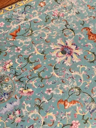 A Chinese famille rose turquoise-ground 'flower scrolls and bats' plaque, later mounted as table, Qianlong