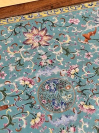 A Chinese famille rose turquoise-ground 'flower scrolls and bats' plaque, later mounted as table, Qianlong