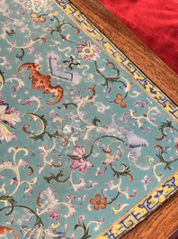 A Chinese famille rose turquoise-ground 'flower scrolls and bats' plaque, later mounted as table, Qianlong