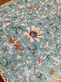 A Chinese famille rose turquoise-ground 'flower scrolls and bats' plaque, later mounted as table, Qianlong