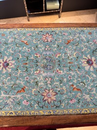 A Chinese famille rose turquoise-ground 'flower scrolls and bats' plaque, later mounted as table, Qianlong