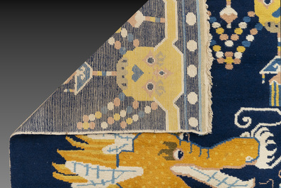 A Sino-Tibetan woollen 'dragon' pillar carpet, 19th C.