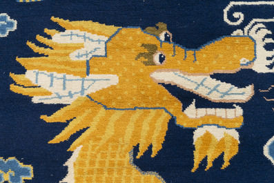 A Sino-Tibetan woollen 'dragon' pillar carpet, 19th C.