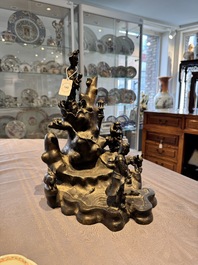 A rare Chinese bronze group depicting two immortals and various animals in a mountainous landscape, Ming