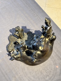 A rare Chinese bronze group depicting two immortals and various animals in a mountainous landscape, Ming