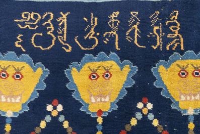 A Sino-Tibetan inscribed woollen 'dragon' pillar carpet, 19th C.