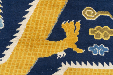 A Sino-Tibetan woollen 'dragon' pillar carpet, 19th C.