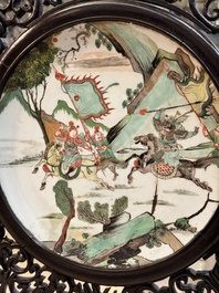 A large Chinese openworked wooden screen with famille verte and famille rose plaques, 18/19th C.