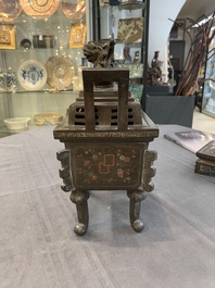 A large Vietnamese copper- and silver-inlaid rectangular 'Buddhist lion' censer and cover on stand, 19th C.