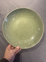 A Chinese Longquan celadon dish with floral design, Ming