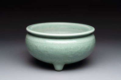 A Chinese celadon-glazed tripod censer with floral anhua design, 18/19th C.
