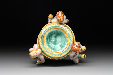 An Italian maiolica triangular salt with winged cherubs, Deruta, 17th C.