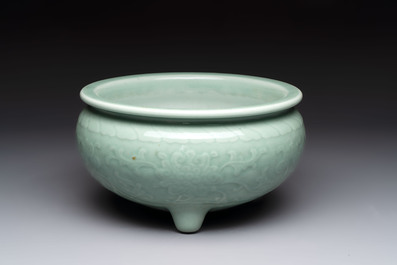 A Chinese celadon-glazed tripod censer with floral anhua design, 18/19th C.