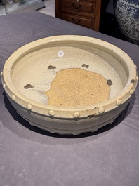 A large Chinese cream-glazed drum-shaped basin, Ming