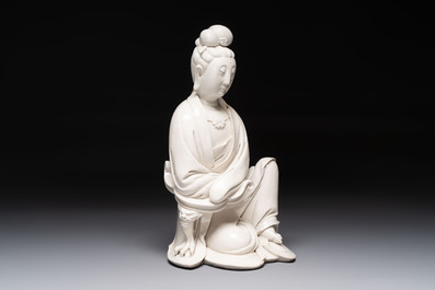 A rare and elegant Chinese Dehua blanc de Chine Guanyin on a wooden stand, Transitional period