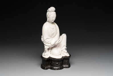 A rare and elegant Chinese Dehua blanc de Chine Guanyin on a wooden stand, Transitional period