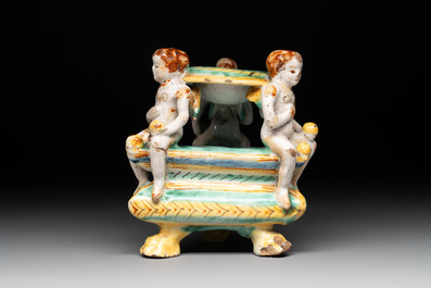 An Italian maiolica triangular salt with winged cherubs, Deruta, 17th C.