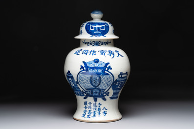 A Chinese blue and white vase and cover with calligraphy and antiquities, 19th C.
