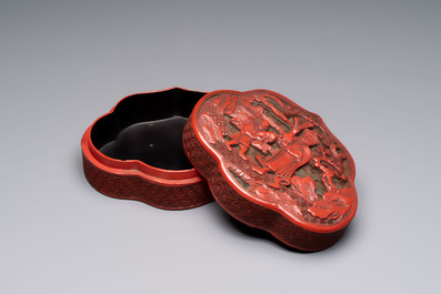 A fine Chinese red cinnabar lacquer ruyi-form 'Ba Man Xian Bao 八蠻獻寶' box and cover, Qianlong