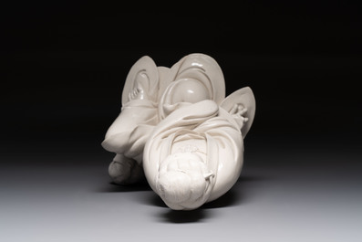 A rare and elegant Chinese Dehua blanc de Chine Guanyin on a wooden stand, Transitional period