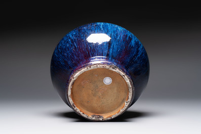 A Chinese flamb&eacute;-glazed vase on wooden stand, 19th C.