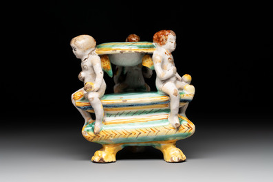 An Italian maiolica triangular salt with winged cherubs, Deruta, 17th C.