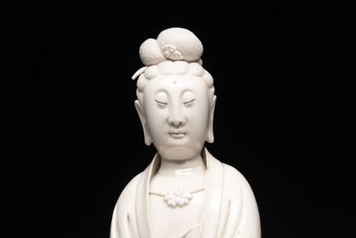 A rare and elegant Chinese Dehua blanc de Chine Guanyin on a wooden stand, Transitional period