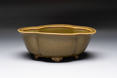 A fine Chinese teadust-glazed quadrifoil jardini&egrave;re with an openworked wooden stand, Yongzheng mark and of the period