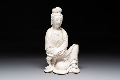 A rare and elegant Chinese Dehua blanc de Chine Guanyin on a wooden stand, Transitional period