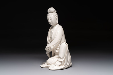 A rare and elegant Chinese Dehua blanc de Chine Guanyin on a wooden stand, Transitional period