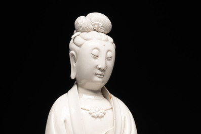 A rare and elegant Chinese Dehua blanc de Chine Guanyin on a wooden stand, Transitional period