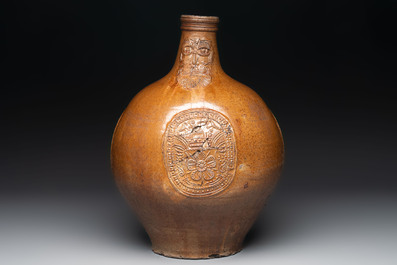 A large brown-glazed stoneware bellarmine jug, 17th C.