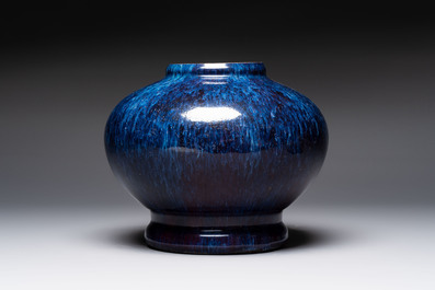 A Chinese flamb&eacute;-glazed vase on wooden stand, 19th C.