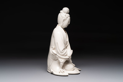 A rare and elegant Chinese Dehua blanc de Chine Guanyin on a wooden stand, Transitional period