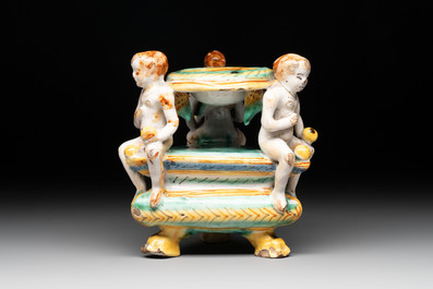 An Italian maiolica triangular salt with winged cherubs, Deruta, 17th C.