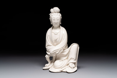 A rare and elegant Chinese Dehua blanc de Chine Guanyin on a wooden stand, Transitional period